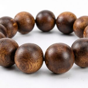 Guyun sinking-grade agarwood bracelet, 18mm beads on elastic cord, low angle showing the full strand