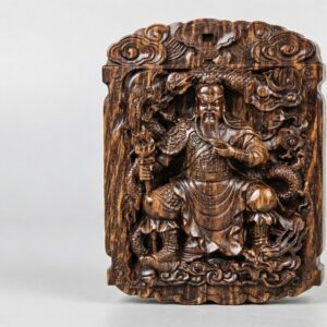 Guan Yu carved sinking-grade agarwood amulet, front view, seated figure with coiled dragon and auspicious cloud border