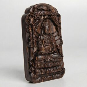 Guanyin agarwood amulet from the opposite angle, lotus seat and cloud border visible
