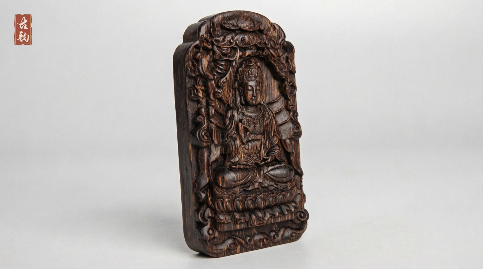 Guanyin agarwood amulet from the opposite angle, lotus seat and cloud border visible