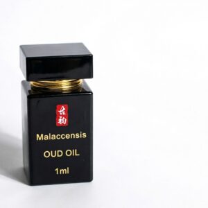 Guyun malaccensis oud oil 1ml, black glass bottle with gold collar, red 古韵 seal and gold lettering, cap resting above